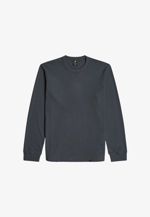 Sudadera de manga larga de color gris oscuro hecha de mezcla de algodón. Cuenta con cuello redondo, puños acanalados y un logo sutil en el pecho. Textura suave.