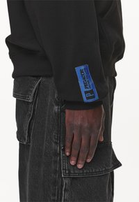 Pegador Luvtröja - black