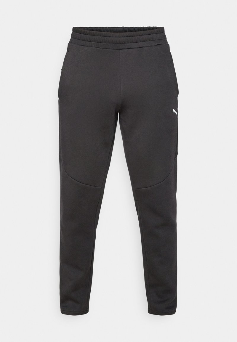 Pantalones de chándal negros hechos de material suave, con una cinturilla elástica ajustable, bolsillos laterales y un sutil detalle de logo en el muslo izquierdo.