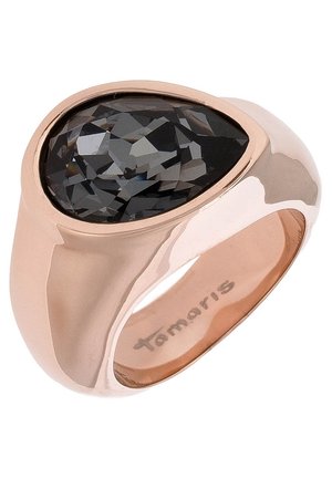 Rose gold ring with a large faceted black teardrop-shaped stone set on top, engraved with "Tamaris" inside the band.