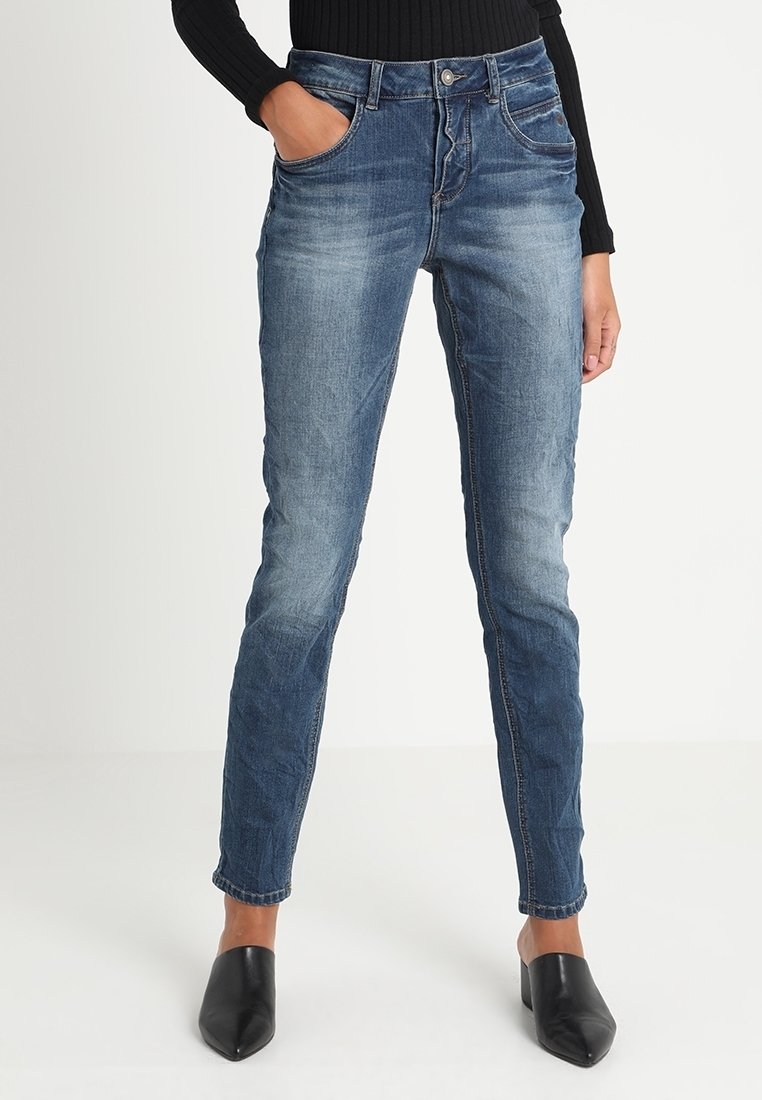 Slim fit niebieskie dżinsy z efektem wyblaknięcia, pięcioma kieszeniami i zapięciem na zamek błyskawiczny. Wykonane z denimu o gładkiej fakturze.