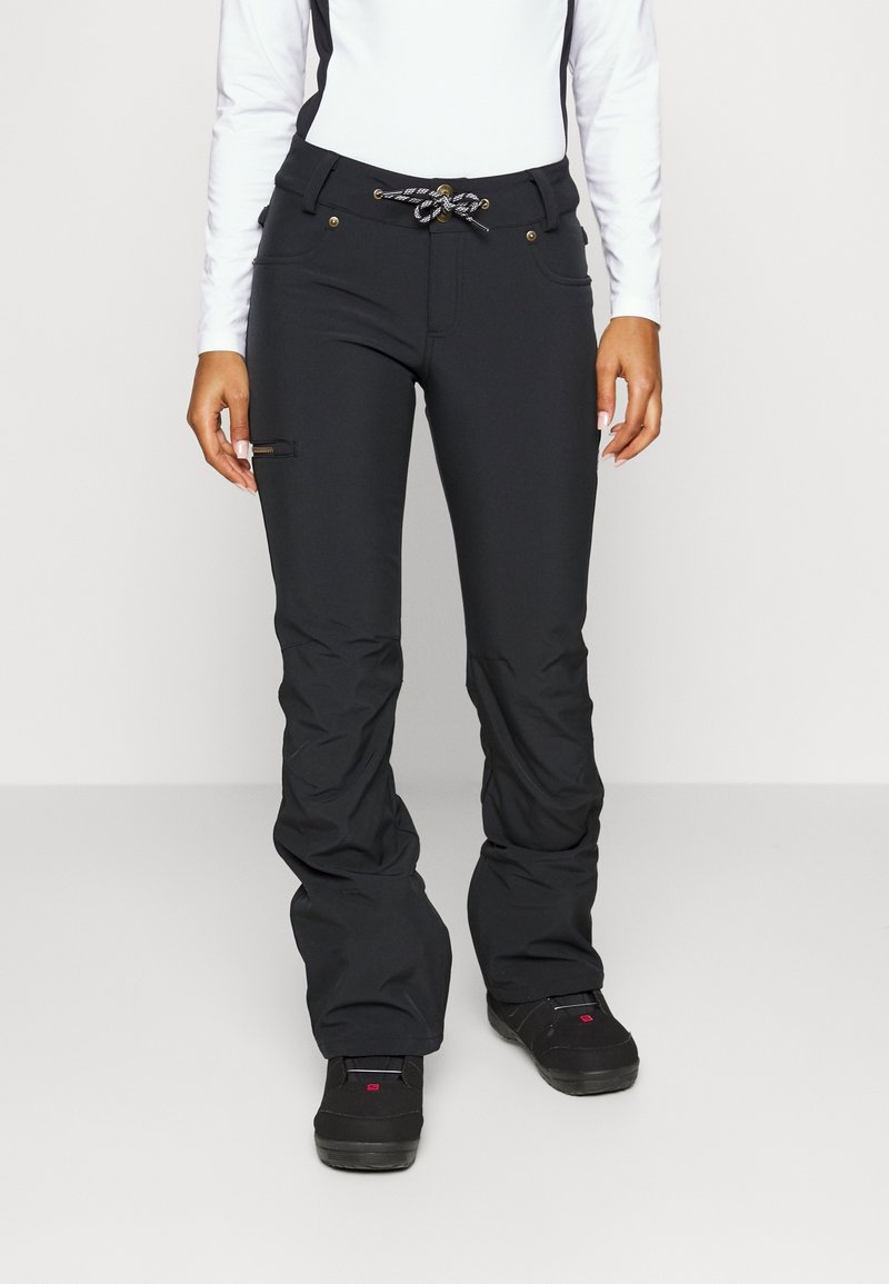 Svarta skidbyxor i flexibelt material med rak ben-design, justerbar dragsko i midjan och detaljer med dragkedjor.