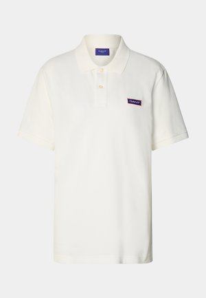 White polo shirt made of cotton with short sleeves, a classic collar, and a small, rectangular embroidered GANT logo on the chest.