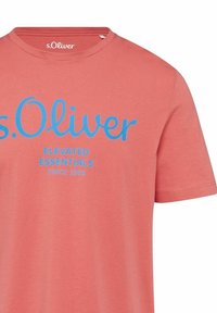 Korallenrotes Baumwoll-T-Shirt mit Rundhalsausschnitt, versehen mit fettem blauen Text: "s.Oliver Elevated Essentials Since 1969" und kurzen Ärmeln.