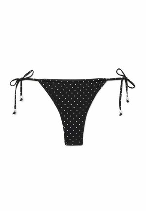 Parte inferior de bikini negra con lunares blancos y lazos laterales ajustables con pequeños detalles de cuentas blancas.