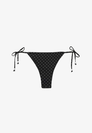 Parte inferior de bikini negra con lunares blancos y lazos laterales ajustables con pequeños detalles de cuentas blancas.