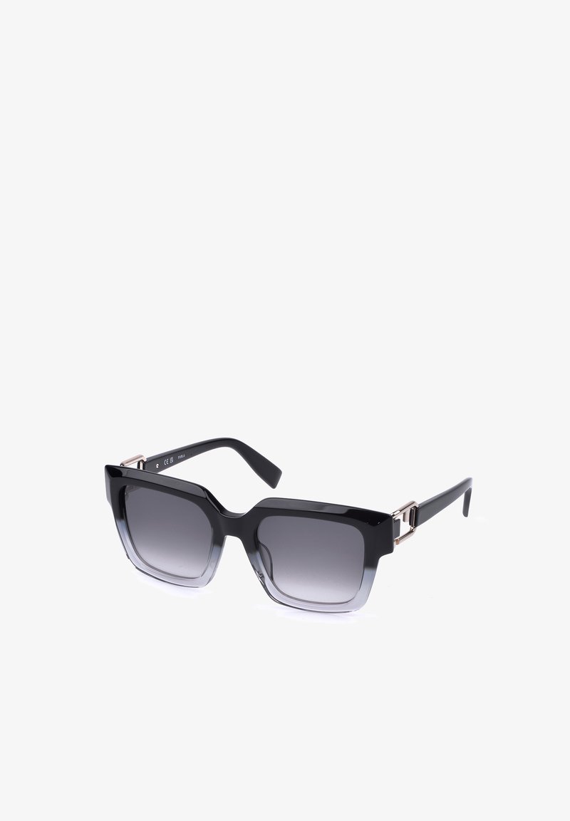 Lunettes de soleil carrées noires surdimensionnées avec verres dégradés foncés et branches fines sur fond blanc.