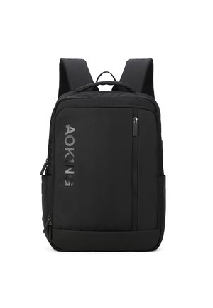 Black nylon backpack with adjustable straps, zippered compartments, and a textured surface. Features a reflective logo on the front.