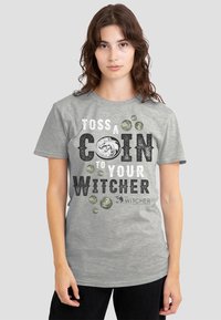 Gray cotton t-shirt featuring the phrase "TOSS A COIN TO YOUR WITCHER" in black and white text, with coin graphics and The Witcher logo.
