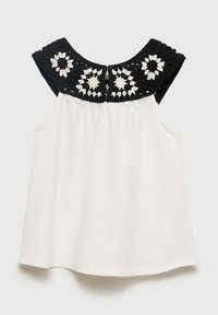 Top bianco senza maniche con yoke all'uncinetto nero caratterizzato da motivi floreali e chiusura con bottoni sul retro. Tessuto morbido con una vestibilità comoda.