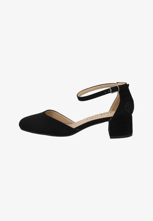 Scarpa nera in suede con tacco, cinturino alla caviglia, punta affusolata e tacco a blocco. Presenta un piccolo dettaglio del logo sul retro del tacco.