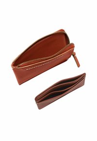 Portefeuille en cuir marron avec fermeture éclair, de forme allongée avec une fermeture éclair dorée, doublure intérieure rouge, comprend un portefeuille plat avec plusieurs compartiments, de couleur assortie.
