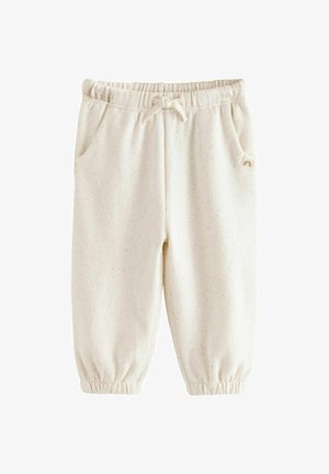 Jasno kremowe spodnie dresowe z miękkiego materiału, z elastycznymi mankietami, bocznymi kieszeniami i wielokolorowymi plamkami dla nadania faktury.