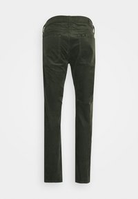 Dark green corduroy pants with a straight leg design, feature back pockets, and stitched detailing. The waistband has a logo label.