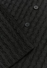 Black textured fabric with a crinkled pattern, featuring two black buttons. The material appears lightweight and slightly stretchy.