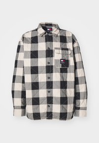 Juodai ir kreminiai langeliais raštuotai apklijuota marškiniai, turintys priekinę kišenę, mygtukų uždarymą ir klasiką apykaklę.