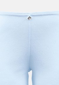 Light blue knitted leggings featuring a subtle heart pattern, a stitched waistband, and a small decorative button at the back.