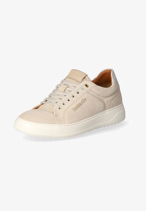 Beige suede sneaker with a smooth white rubber sole, contrast stitching, rounded toe, and flat laces; brand name embossed on the side.