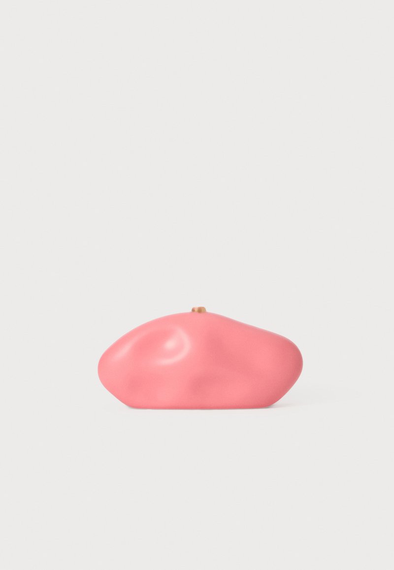 Pink clutch bag with an organic, rounded shape, matte finish, and a small gold clasp detail on top. Smooth texture with no visible patterns.