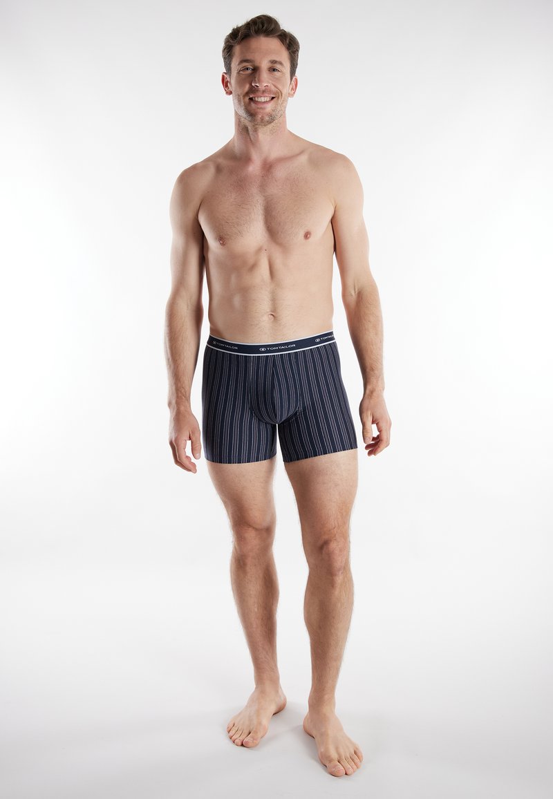 Men's navy striped boxer briefs with a fitted design, elastic waistband, and soft fabric for comfort. Vertical stripes add a subtle pattern.