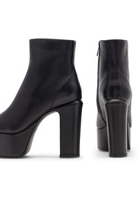 Čierne kožené členkové topánky s elegantným dizajnom, okrúhlou špičkou a hrubými vysokými podpätkami. Hladká textura s bočným zipsom.