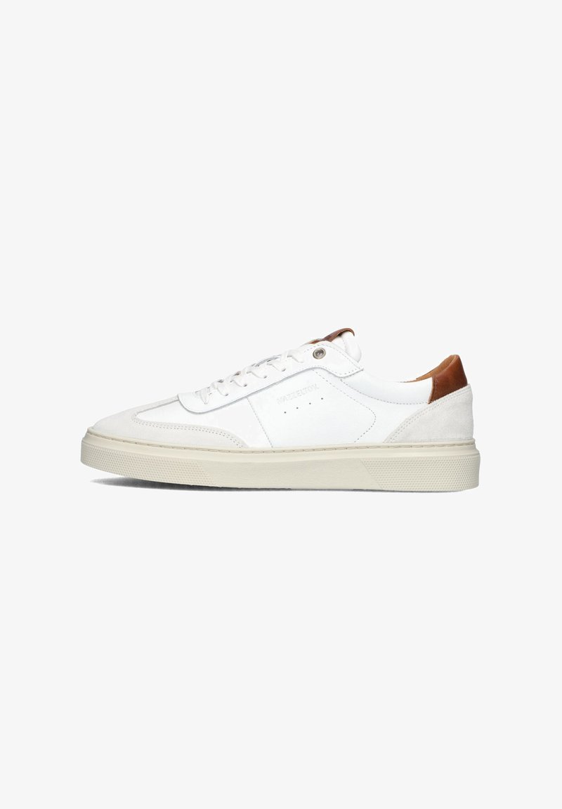 White sneaker with leather and suede accents, tan heel, flat laces, round toe, and textured sole with a light-colored midsole.