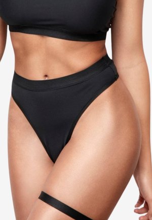 Schwarzes zweiteiliges Badeanzug-Set mit einem kurzen Top mit breitem Bund und hochgeschnittenem Tanga-Höschen, gefertigt aus glattem, dehnbarem Material.