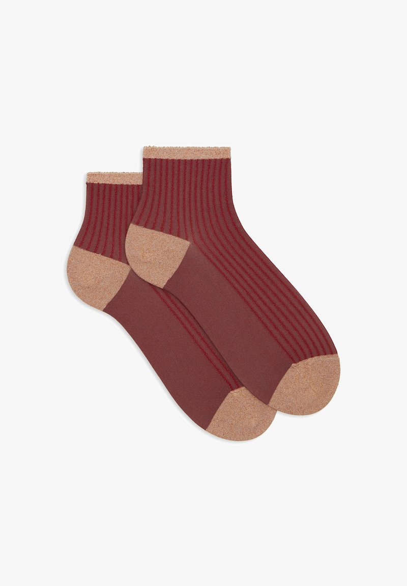 Red striped socks with a beige ribbed cuff and toe. Made from soft material, featuring a smooth texture and contrasting accents.