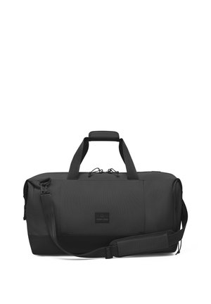Black duffel bag made of textured material, featuring dual handles, an adjustable shoulder strap, and a front logo patch.