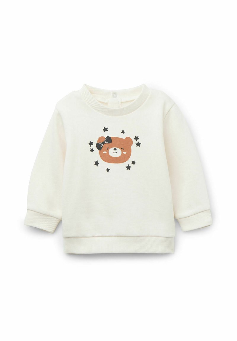 Cremfarbener Pullover mit Rundhalsausschnitt, der ein gedrucktes Gesicht eines braunen Bären und schwarze Sterne zeigt. Weiches Material, gerippte Bündchen und Saum.