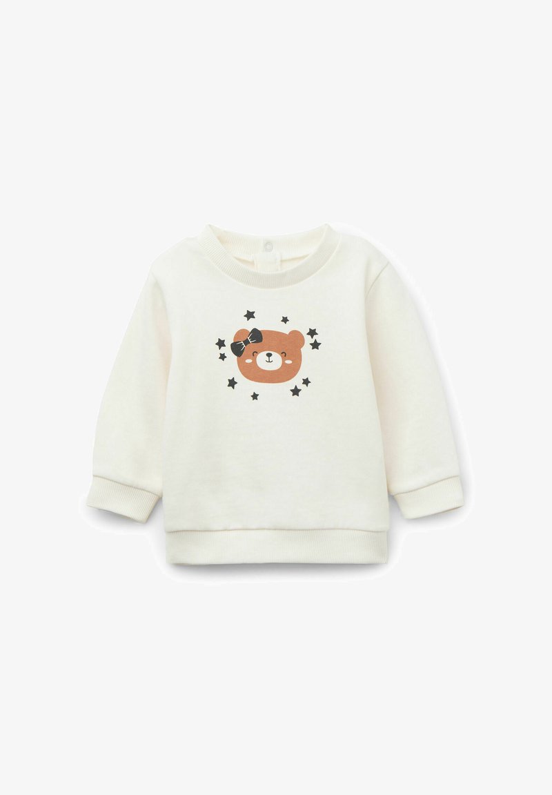 Cremfarbener Pullover mit Rundhalsausschnitt, der ein gedrucktes Gesicht eines braunen Bären und schwarze Sterne zeigt. Weiches Material, gerippte Bündchen und Saum.