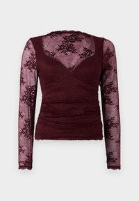 Burgundi pikkade varrukate top, millel on pitskangas, lillemustrid ja volditud esiosa. Pehme tekstuur, lainelise kaelaaugu ja varrukaotsadega.