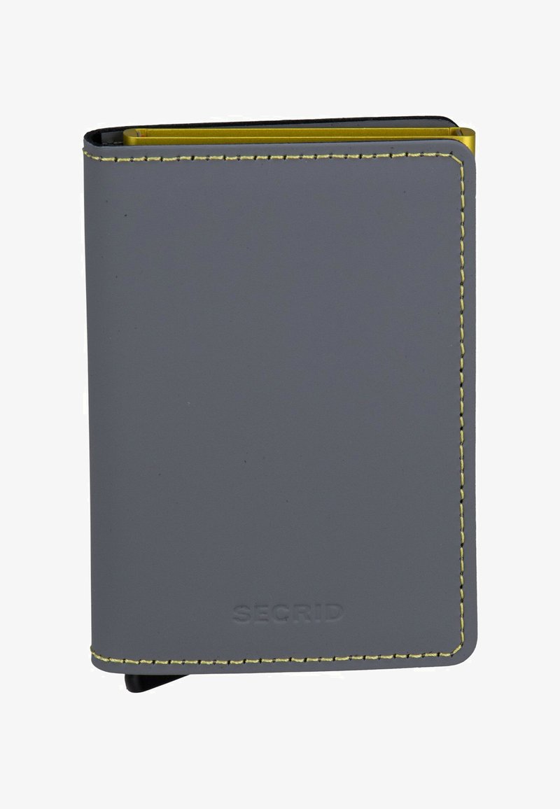 Cartera gris hecha de material suave con costuras amarillas. Presenta un diseño delgado con bordes redondeados y una marca en relieve en la parte inferior.