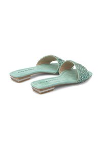 Chanclas de color verde menta con textura de ante, adornadas con strass de color azul claro en las correas, con un pequeño tacón geométrico.