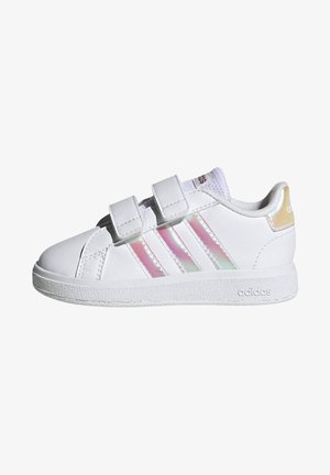 Zapatilla blanca con dos correas de Velcro, franjas iridiscentes brillantes, puntera redondeada y suela de goma texturizada. Logo mostrado en el talón.