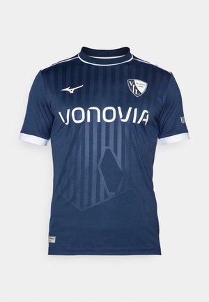 Navy blue soccer jersey with vertical stripes, white accents, and logo. Made of fabric with a smooth texture and crew neck design.