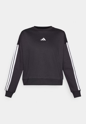 Crna dukserica dugih rukava, s bijelim Adidas logotipom na prsima i bijelim prugama niz svaku rukavu. Mekani materijal, okrugli izrez.