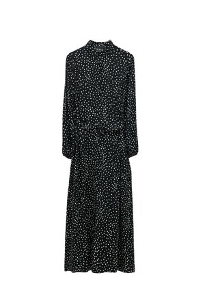 Black dress with white polka dots, long sleeves, collared neckline, fitted waist, and flowing skirt. Lightweight, smooth fabric.