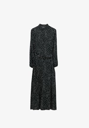 Černé šaty s bílými puntíky, dlouhé rukávy, límečkový výstřih, vypasovaný pas a volná sukně. Lehká, hladká tkanina.