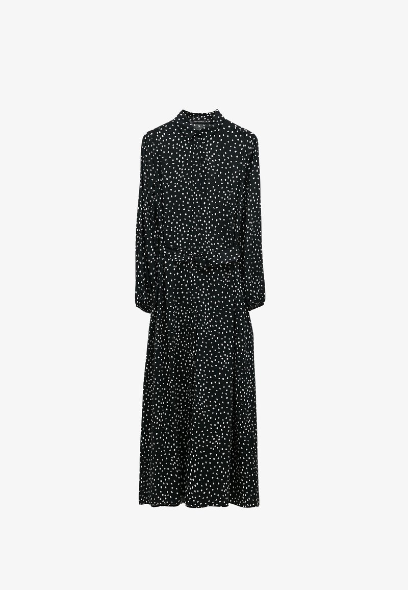 Černé šaty s bílými puntíky, dlouhé rukávy, límečkový výstřih, vypasovaný pas a volná sukně. Lehká, hladká tkanina.