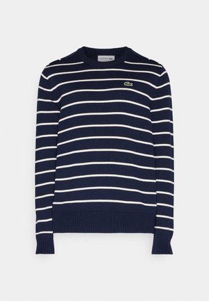 Marineblå stribet sweater med hvide horisontale striber, ribbede manchetter og nederste kant, samt et lille grønt krokodille-logo på brystet.