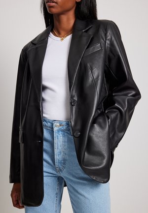 ÜBERGROSSER - Faux leather jacket - black