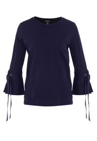 Námořnická modrá halenka s dlouhým rukávem vyrobená z měkké látky, s rozšířenými rukávy se stahovacími detaily a zlatými prvky na uzlech. Kulatý výstřih.