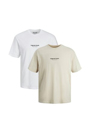 Two plain short-sleeve crew neck t-shirts in white and beige with small centered "Originals Studio" text on the chest.