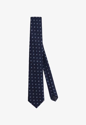 Cravate bleu marine en tissu texturé, dotée d'un motif géométrique de petits diamants et carrés blancs sur toute sa longueur.
