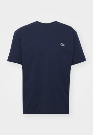 Navyblaues Baumwoll-T-Shirt mit kurzen Ärmeln, Rundhalsausschnitt und einem kleinen grünen Krokodil-Logo auf der linken Brust. Weicher Stoff, lässiges Design.