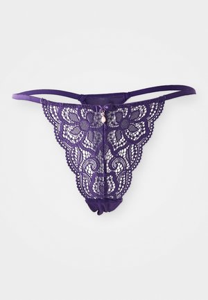 Purple lace thong with floral pattern, thin straps, and a decorative bow at the front. Features a soft elastic waistband and ruched back.