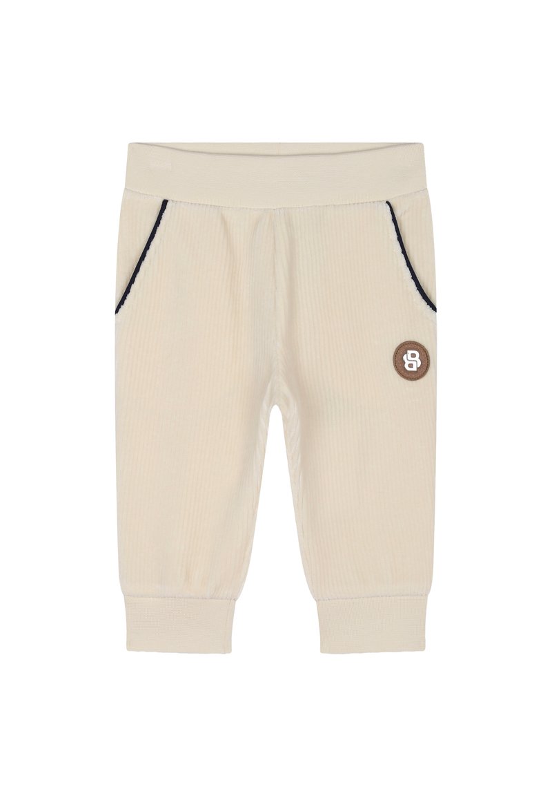 Joggers in velluto a coste nocciola chiaro con cuciture blu, due tasche laterali e una piccola etichetta in pelle marrone sul fronte. Tessuto morbido, vita elasticizzata.