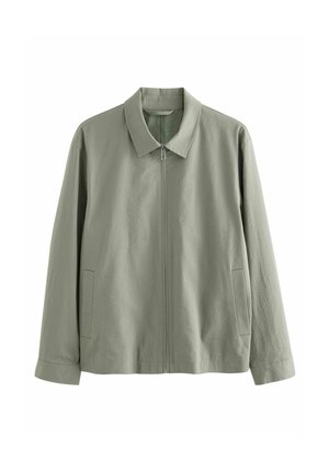 Veste zippée vert clair avec col et manches longues, dotée de deux poches latérales et d’un tissu subtilement texturé.