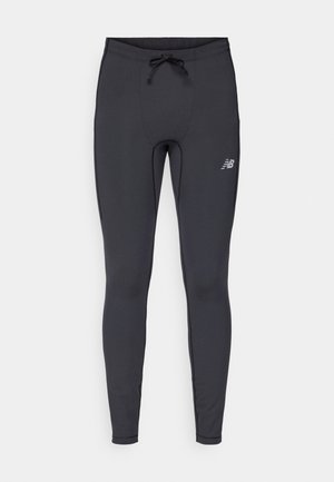 Leggings deportivos negros hechos de tejido elástico. Cuentan con una cintura ajustable con cordón y un pequeño logo reflectante en el muslo derecho frontal.
